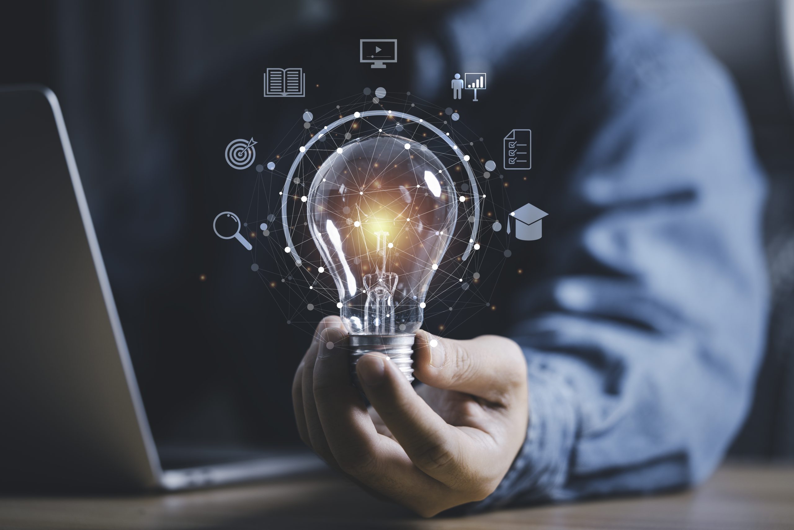 Businessman hand holding lightbulb with connection line and knowledge icon to creative smart thinking for inspiration and innovation with network concept.